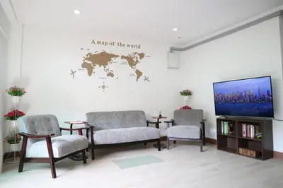 a living room with two chairs and a flat screen tv at Happyhouse Laksi station (PK14) in Lak Si