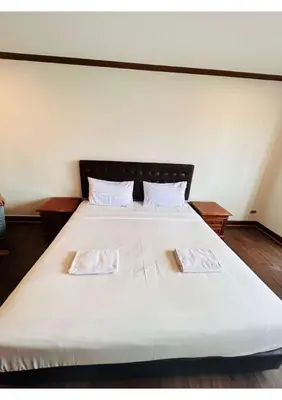 a large white bed with two pillows on it at Affordable Serviced Apartment Nana - Omni Tower Sukhumvit location in Bangkok
