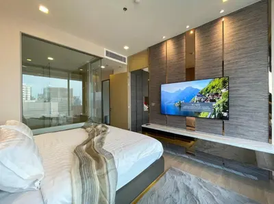 a bedroom with a flat screen tv on a wall at Ultimate Luxurious in Prime Bangkok Asoke in Bangkok