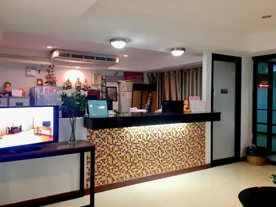 a restaurant with a counter with a tv in a room at Double DD House at MRT Sutthisarn in Bangkok