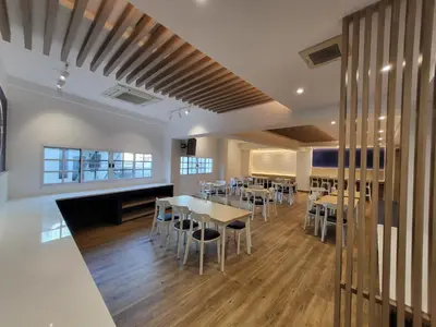 a restaurant with tables and chairs in a room at The Raya Surawong Bangkok in Bangkok