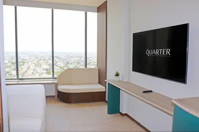 a living room with a tv and a chair at The Quarter Ratchayothin by UHG in Bangkok