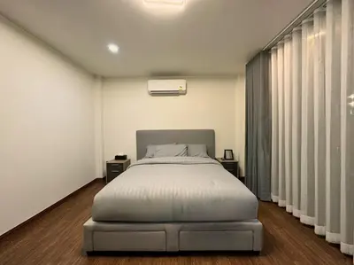 a bedroom with a large bed and a window at Arun Heaven Bangkok in Bangkok Noi