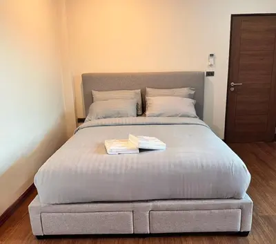 a bed with two books on it in a bedroom at Arun Heaven Bangkok in Bangkok Noi