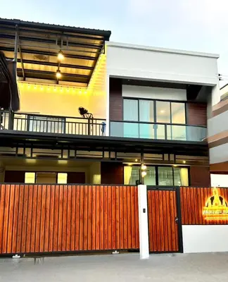 a house with a wooden fence in front of it at Arun Heaven Bangkok in Bangkok Noi