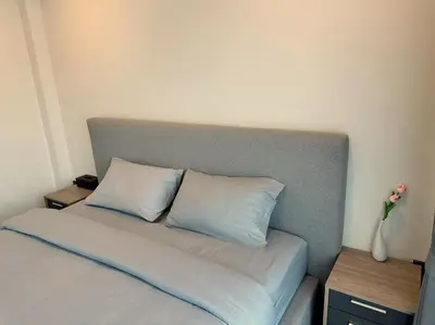 a bed with two pillows on it in a room at Arun Heaven Bangkok in Bangkok Noi