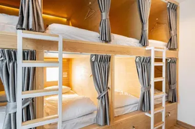 a room with bunk beds in a room at Cape Ratchada. in Bangkok