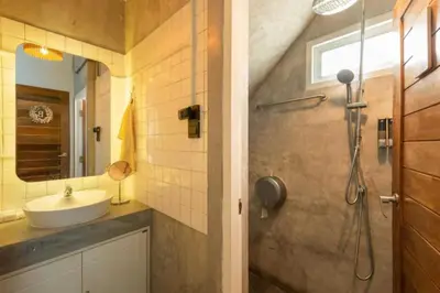 a bathroom with a sink and a shower at Cape Ratchada. in Bangkok