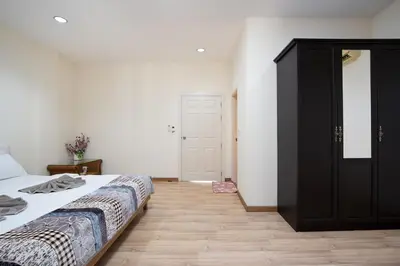 a bedroom with a bed and a black cabinet at AreeHouse \u66fc\u8c37 300\u5e73\u65b9 \u7368\u68df\u5225\u5885 \u5bb6\u5ead\u9996\u9078 \u8fd17-11 \u8d85\u5e02 MRT in Bangkok