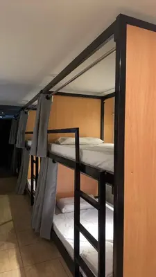 a group of bunk beds in a room at The Cute Silom hostel in Bangkok