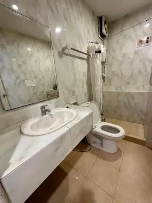 a bathroom with a sink and a toilet at The Cute Silom hostel in Bangkok