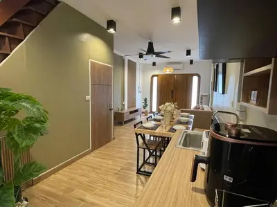 a living room with a kitchen and a dining room at Private house with Pagoda view, near Grand Palace in Bangkok