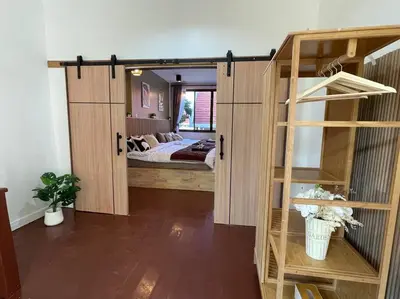 a room with a bed and a room with a book shelf at Private house with Pagoda view, near Grand Palace in Bangkok