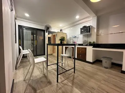 a kitchen with a table and chairs in a room at Cozy home @ Chatcuchak/中文服务 in Bang O