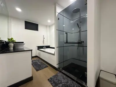 a bathroom with a glass shower and a sink at Cozy home @ Chatcuchak/中文服务 in Bang O