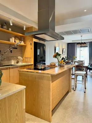 a large kitchen with wooden cabinets and a kitchen island at Brown's Residence in Bangkok