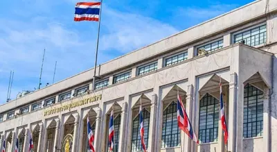 a building with three flags on top of it at Alameda Suites Hotel in Bangkok