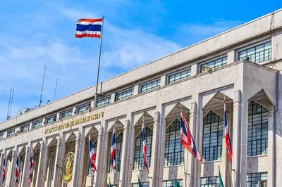 a building with a flag on top of it at Alameda Suites Hotel in Bangkok