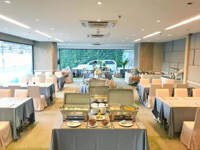 a banquet hall with tables and chairs and a car at Clef Hotel Bangkok in Ban Khlong Samrong
