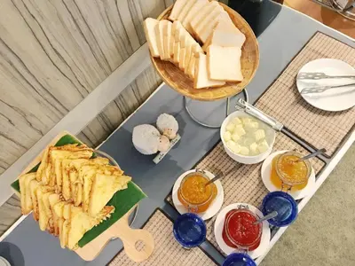 a table with a tray of food on top of it at Clef Hotel Bangkok in Ban Khlong Samrong