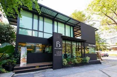 a store front of a building with plants at BB House Mini Suite Hotel in Ban Zong Katiam