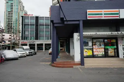 a city street with cars parked in front of a store at The Bangkok Venice Suite in Bangkok