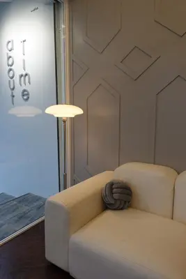 a living room with a couch and a lamp at AboutTime Bangkok in Bangkok