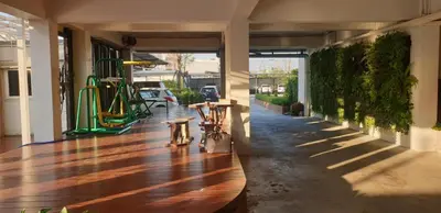 a hallway of a building with a wooden floor at THOUSAND-TEN THOUSAND HOTEL in Sathani Wat Sing