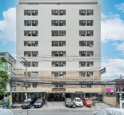 a large white building with cars parked in front of it at SURANG MANSION in Ban Bang Khen (1)