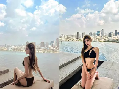 a woman in a black bikini sitting on the edge of the water at BTS Ekkamai-free pool-bus to pattya in Bangkok