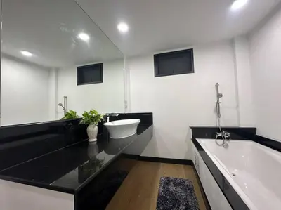 a bathroom with a tub and a sink and a bath tub at Private cozy house @Chatcuchak in Bang O
