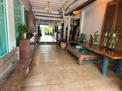 a hallway with a table and benches in a building at Tanwa Suite - MRT Ratchadapisek in Bangkok
