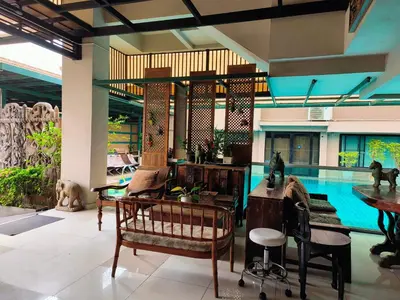 a living room with a pool and a table and chairs at Tanwa Suite - MRT Ratchadapisek in Bangkok