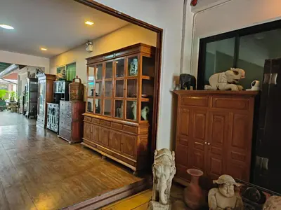a room with a large wooden cabinet in a room at Tanwa Suite - MRT Ratchadapisek in Bangkok