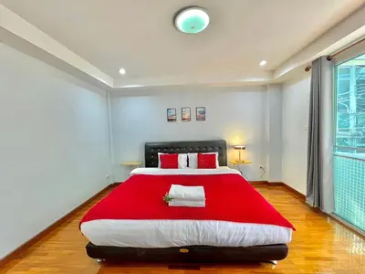 a bedroom with a large bed with a red blanket at S52 Near On nut BTS 300m*7-11 in Phra Khanong
