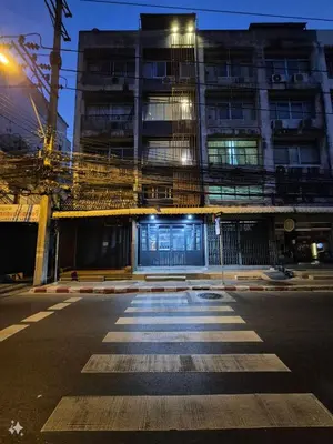an empty street in front of a building at night at Bangkok vibe, City House, 7 mins to BTS, City center, Private room in Sathon, Private bathroom, Bangkok, Thailand in Bangkok