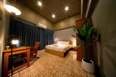 a bedroom with a bed and a desk with a laptop at 189summer villa曼谷中心Asok&Thong Lor顶级豪宅庄园泳池别墅 in Bangkok