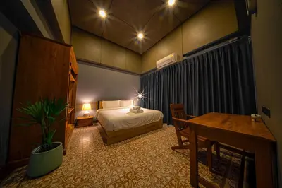 a bedroom with a bed and a table and a desk at 189summer villa曼谷中心Asok&Thong Lor顶级豪宅庄园泳池别墅 in Bangkok