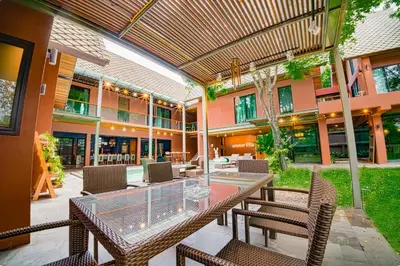 a patio with a table and chairs and a building at 189summer villa曼谷中心Asok&Thong Lor顶级豪宅庄园泳池别墅 in Bangkok
