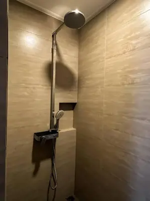 a bathroom with a shower with a light on the wall at 1897summer villa 曼谷中心7卧Asok&Thong Lor800平米海天别墅 in Bangkok