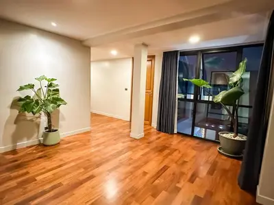 a living room with two potted plants and a hard wood floor at 1897summer villa 曼谷中心7卧Asok&Thong Lor800平米海天别墅 in Bangkok