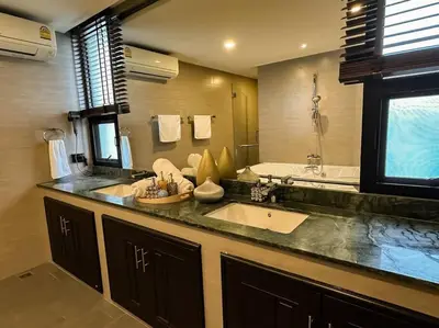 a large bathroom with a sink and a tub at 1897summer villa 曼谷中心7卧Asok&Thong Lor800平米海天别墅 in Bangkok