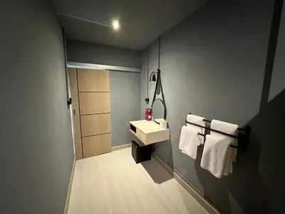 a bathroom with a sink and white towels at Phuket vibe, City House, 7 mins to BTS, City center, Private room in Sathon, Private bathroom, Bangkok, Thailand in Bangkok