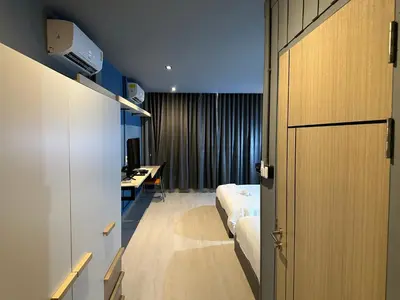 a hotel room with a bed and a desk at Phuket vibe, City House, 7 mins to BTS, City center, Private room in Sathon, Private bathroom, Bangkok, Thailand in Bangkok