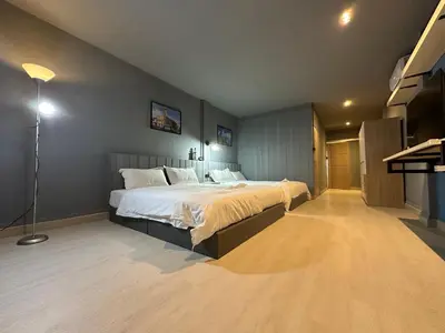 a bedroom with a large bed in a room at Phuket vibe, City House, 7 mins to BTS, City center, Private room in Sathon, Private bathroom, Bangkok, Thailand in Bangkok