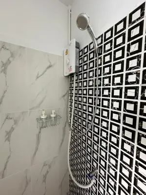 a shower in a bathroom with a black and white tile at Phuket vibe, City House, 7 mins to BTS, City center, Private room in Sathon, Private bathroom, Bangkok, Thailand in Bangkok