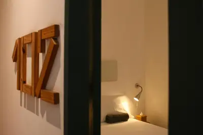 a room with a bed with a lamp on it at T-Boutique Hostel - Hua Lamphong in Bangkok