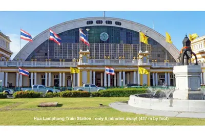 a large building with a fountain in front of it at T-Boutique Hostel - Hua Lamphong in Bangkok