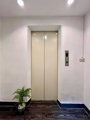 a hallway with a door and a potted plant at DiscoveryHome5 at Pratunammarket in Bangkok