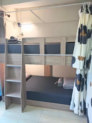 a bedroom with bunk beds in a room at Panda Lodge Home Stay in Bangkok